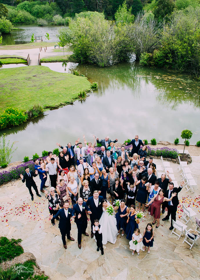 Group shot overlooking the lake at a Lake House, Daylesford wedd