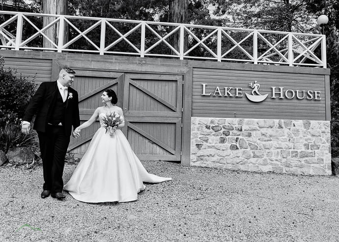 Bride and groom with Lake House sign behind them