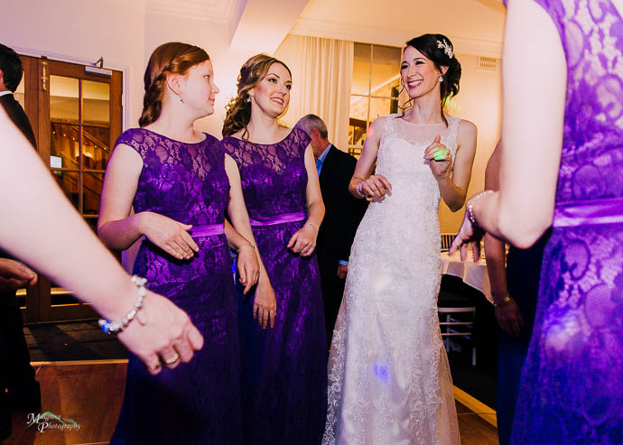 Bridesmaids dancing with bride at a wedding reception