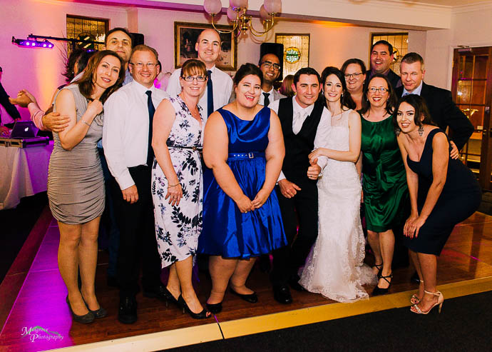 Friends gather for a photo at a wedding reception