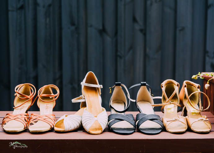 Bride and Bridesmaid shoes lined up on a bench