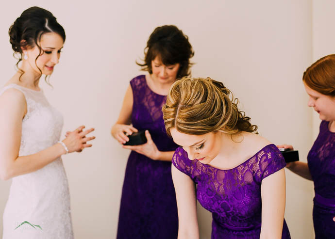 Bridesmaids helping Bride with jewellery