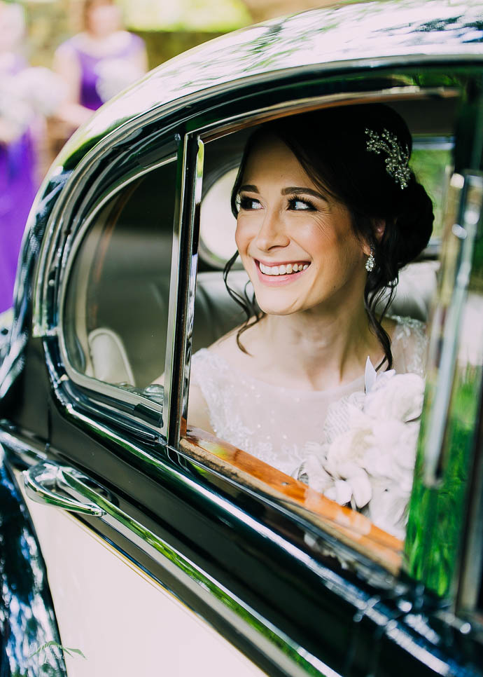 Bride looking out the window of her bridal car