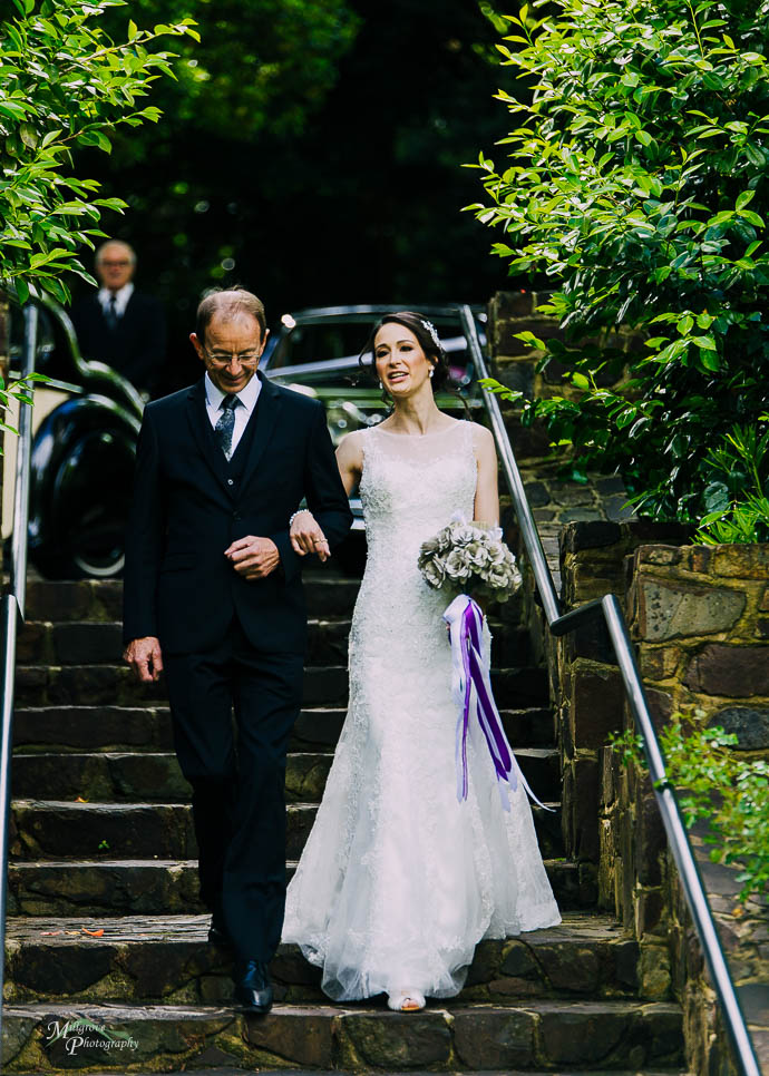 Bride and father walking down steps at a wedding at Marybrooke Manor, Sherbrooke