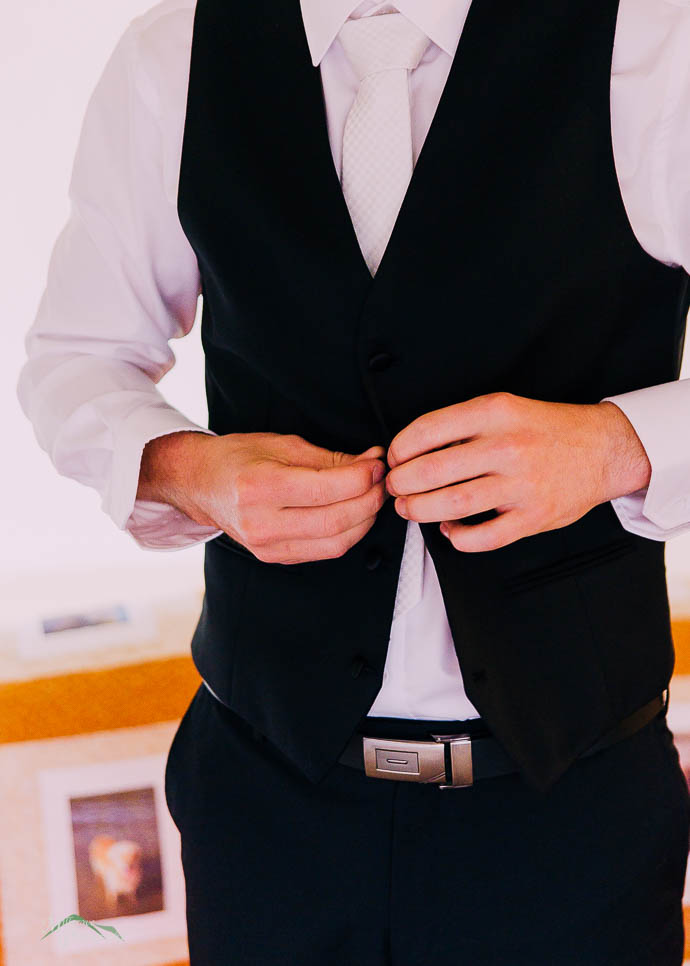 Groom putting on waistcoat