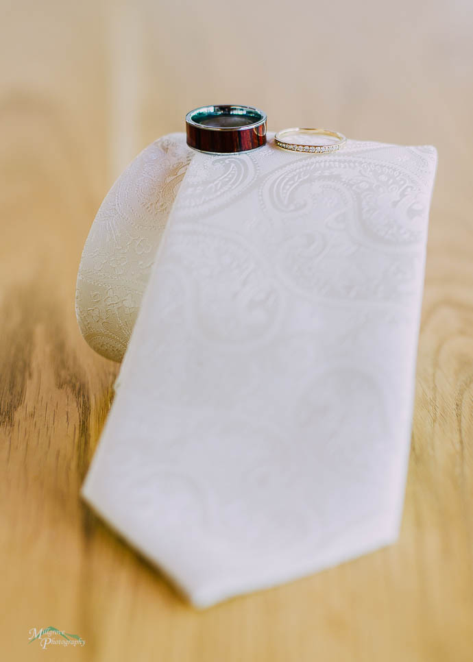 Wedding rings balanced on a white tie