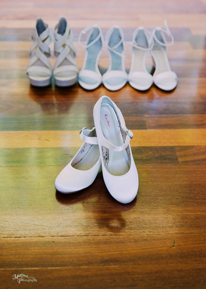 Bride’s shoes with Bridesmaids shoes behind