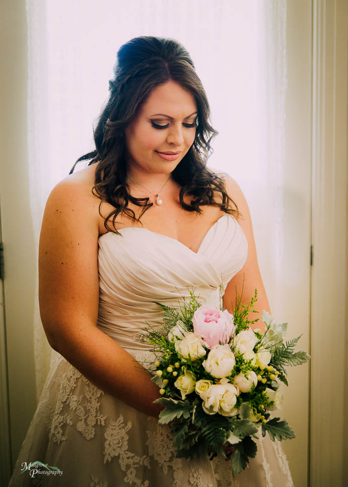 Bride looking down at her flowers