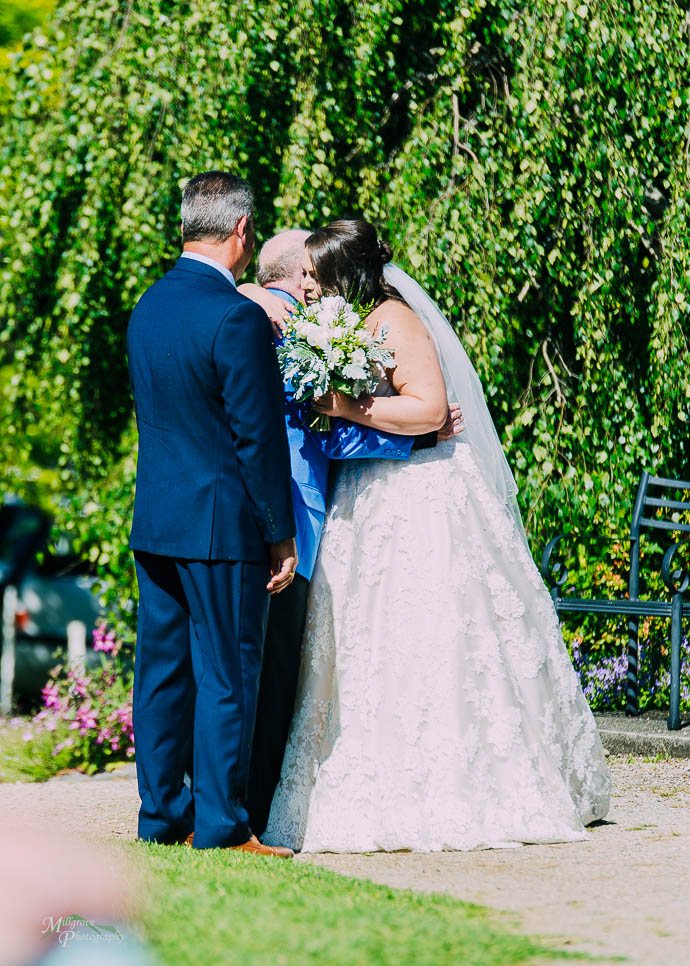 Bride kissing grandfather on the cheek