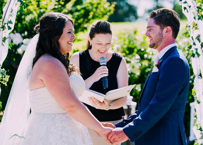 Bride and Groom holding hands in a wedding ceremony at Warburton Golf Club