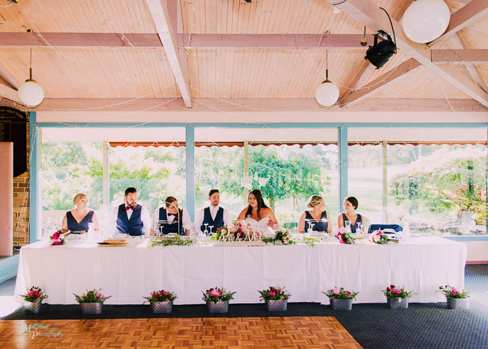Bride and Groom sit down at bridal table at Warburton Golf Club