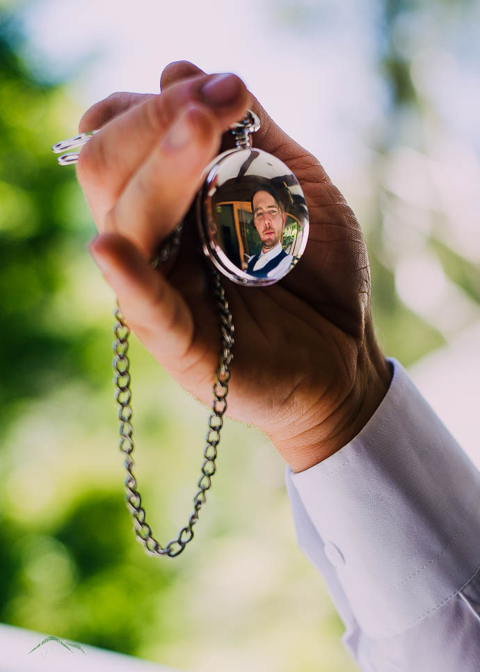 Groom’s reflection in pocket watch