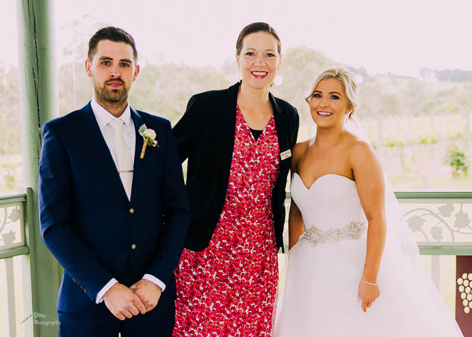 Celebrant in a photo with bride and groom