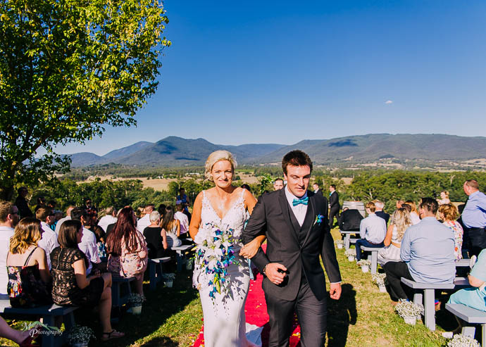 A bride and gorom walking up the aisle after a Riverstone Estate Wedding