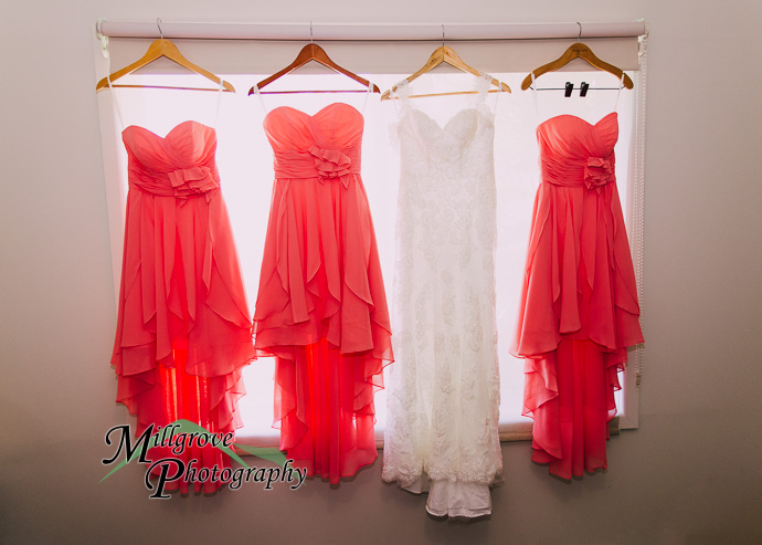 Four dresses hanging in a window