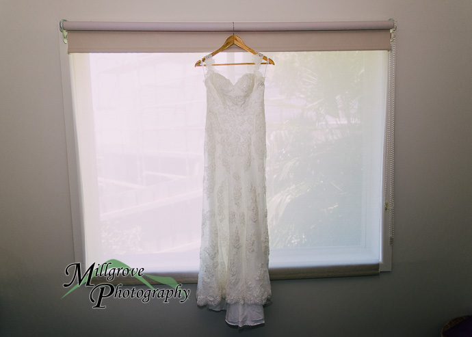 A wedding dress hanging on a door