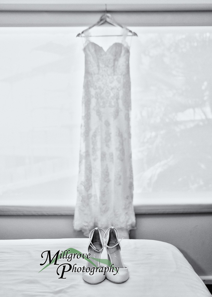 A wedding dress hanging in the window