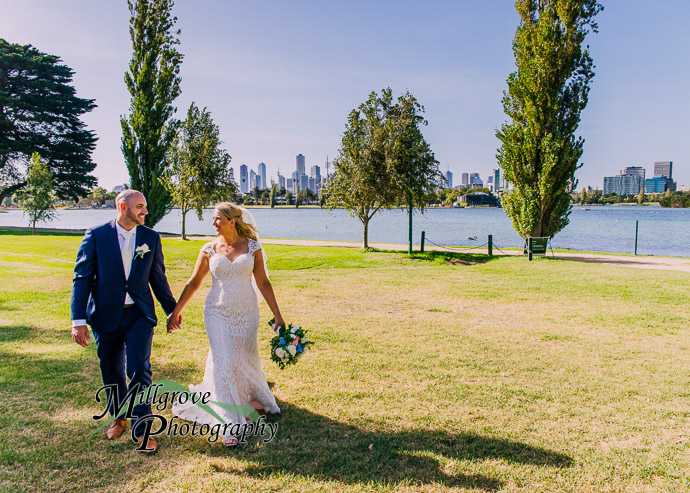 A man and woman walking by Albert Park Lake