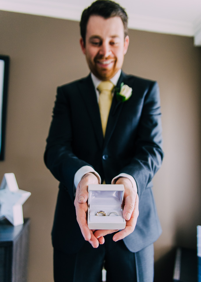 Man holding wedding rings in a box