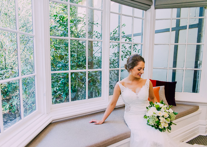 Bride sitting near a window