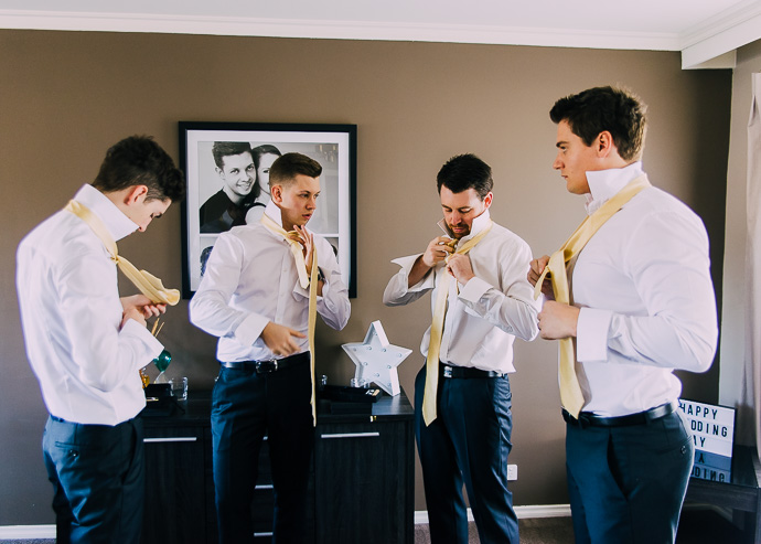 Groom doing up his tie