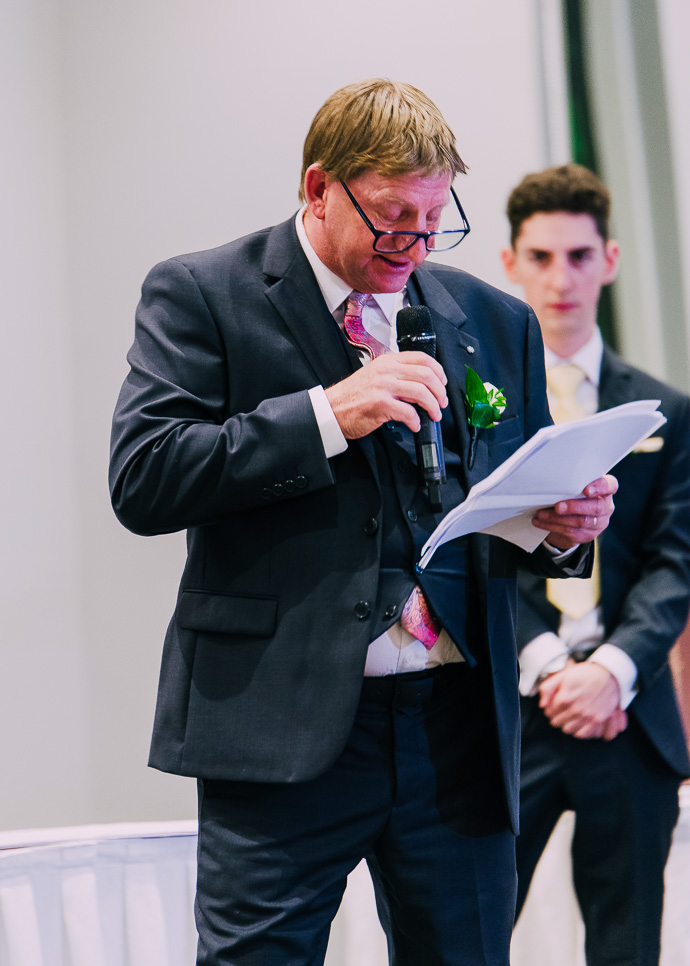 man reading a speech at a wedding