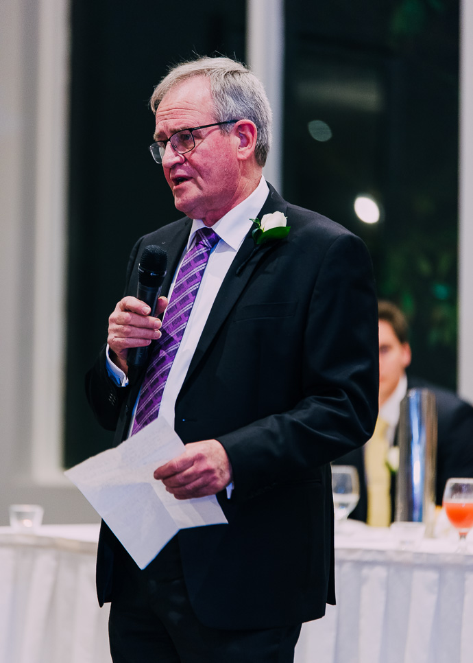 man reading a speech at a wedding