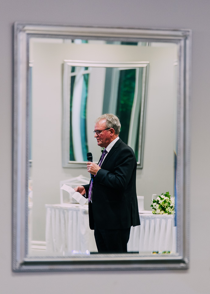 man reading a speech at a wedding