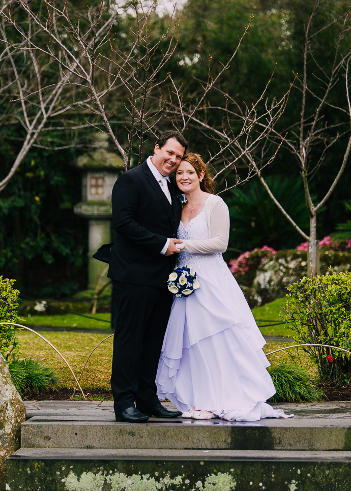 A bride and groom in the Japanese garden at the Melbourne Zoo garden