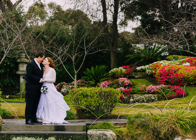 A bride and groom in the Japanese garden at the Melbourne Zoo garden
