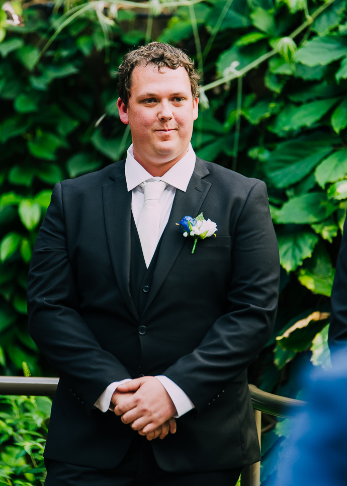 A man standing dressed in a suit