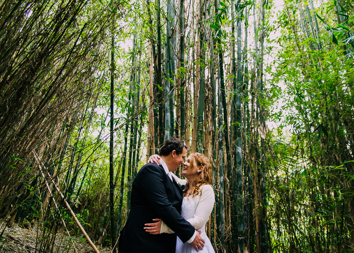 Melbourne Zoo Weddings - A bride and groom kissing with bamboo behind them