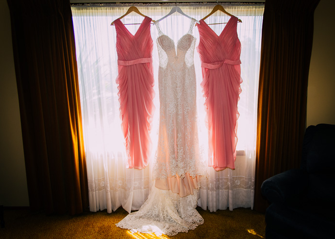 Three dresses hangin in a window