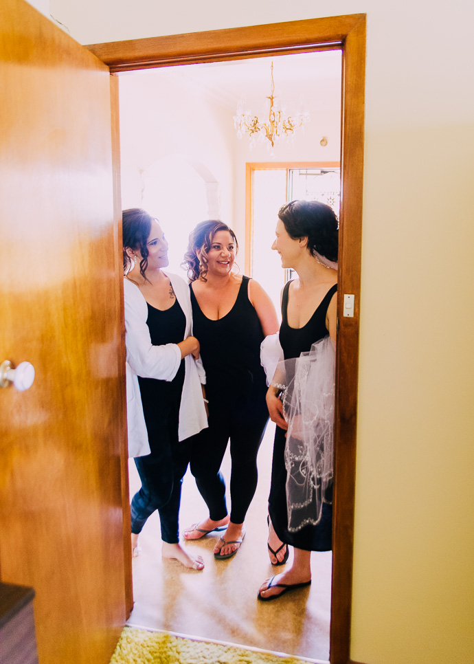 Three women standing in a doorway.