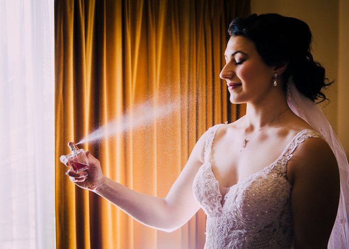 A bride spraying perfume