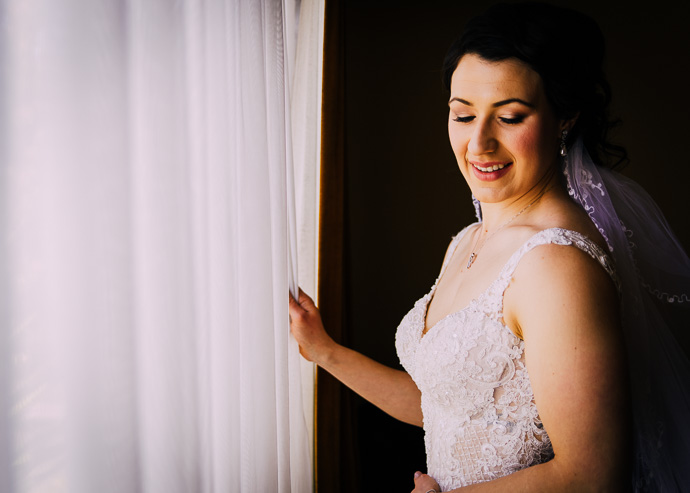 A bride standing by the window