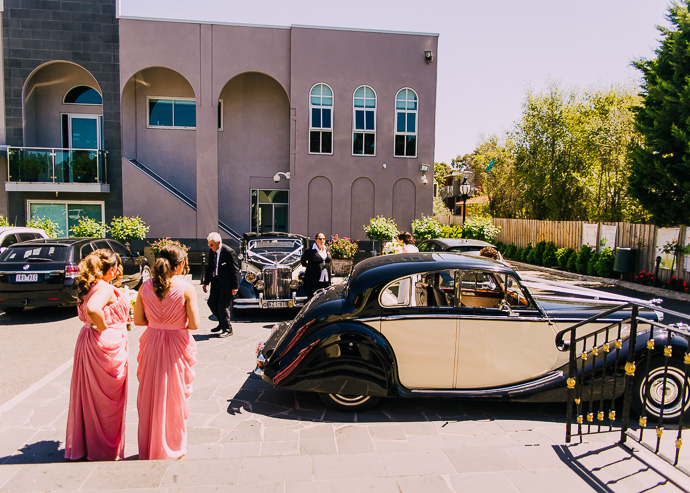 A wedding car and some bridesmaids