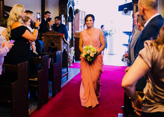 A bridesmaid walking down the aisle