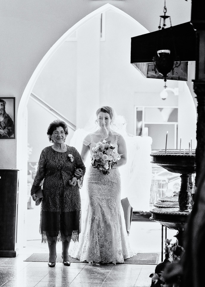 A bride and her mother walking down the aisle