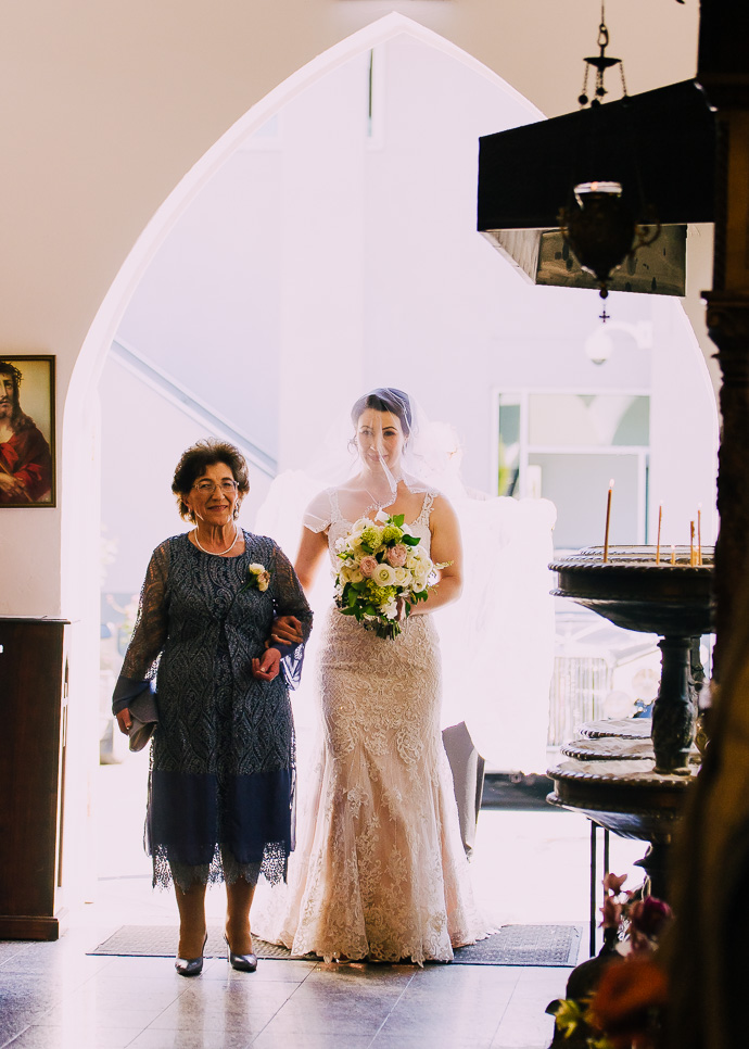 A bride and her mother walking down the aisle