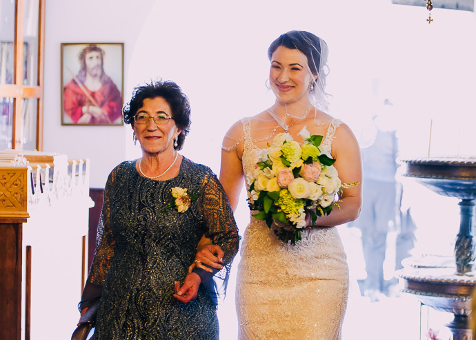 A bride and her mother walking down the aisle