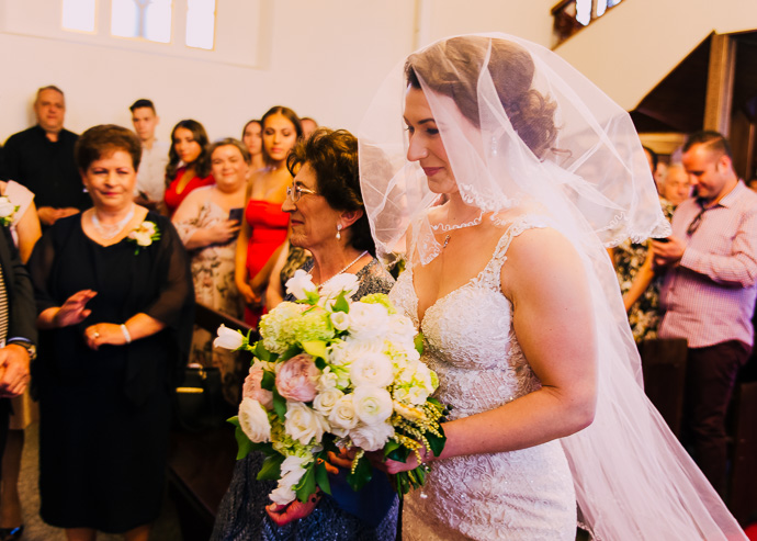 A bride and her mother walking down the aisle