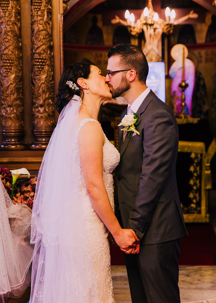 A bride and groom sharing a first kiss