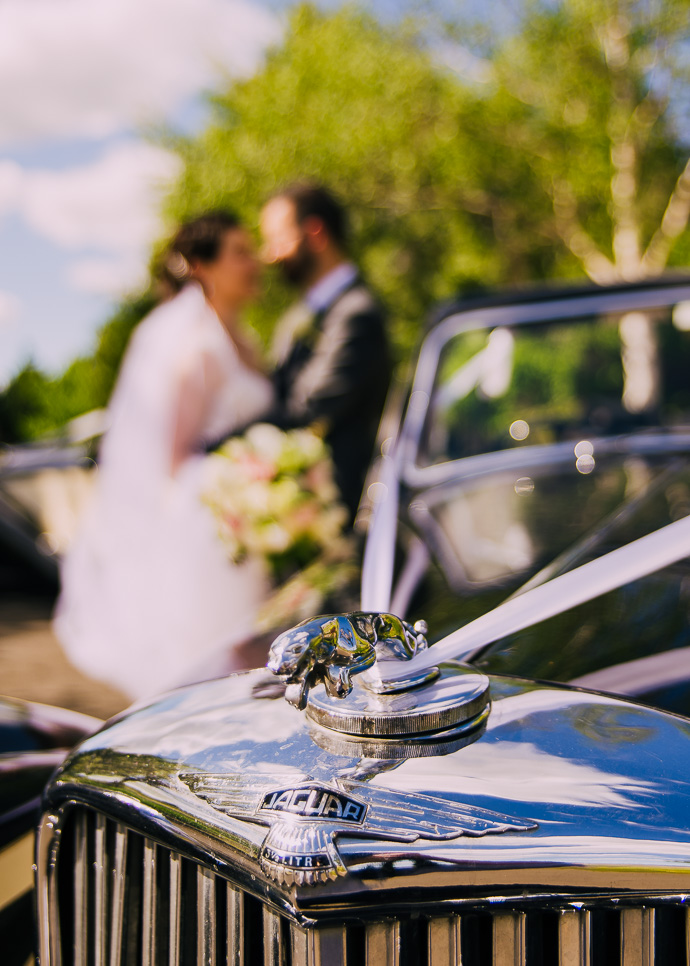 A groom and groomsmen with a wedding car outside Witchmount Estate
