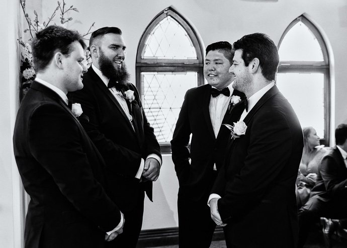 Foru men in suits, talking