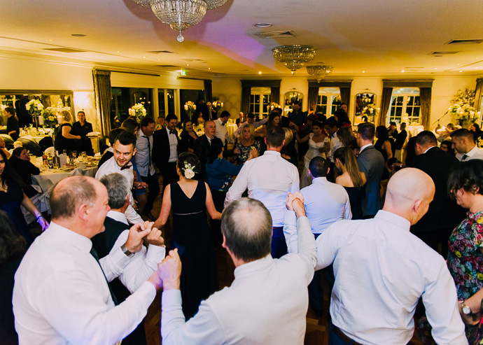 Guests celebrating and dancing at a wedding reception