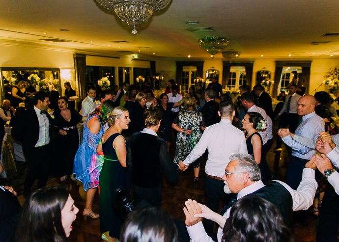Guests celebrating and dancing at a wedding reception