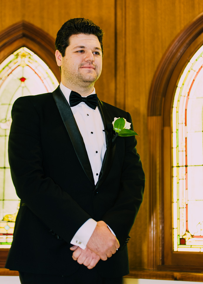 A groom looking at a bride
