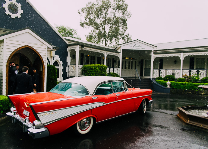 Yarra Valley Weddings - a red ChevyBel Air outside a chapel