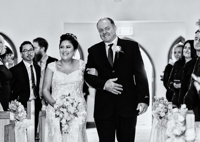 A bride and her father walking down the aisle